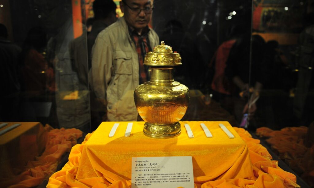 A replica of the golden urn and ivory slips bestowed by the Qianlong Emperor of the Qing Dynasty to the Eighth Dalai Lama, displayed at a museum in Lhasa, Tibet Autonomous Region, on August 11, 2014. (Photo: cnsphoto)